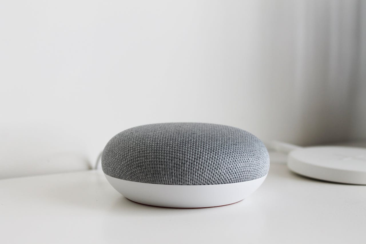 A sleek and modern smart speaker on a clean white surface, perfect for tech-inspired decor.